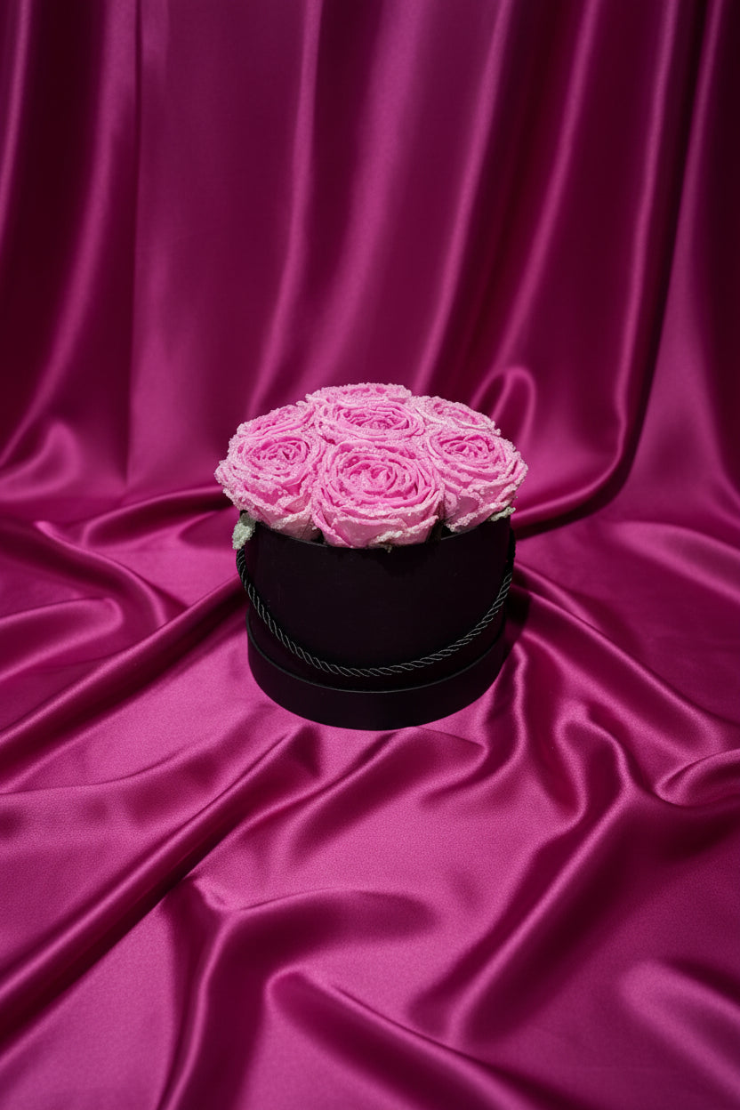 Black box with pink roses on a black background
